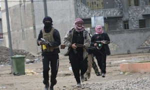 Al-Qaida gunmen patrol during clashes with Iraqi security forces in Falluja on Sunday,.