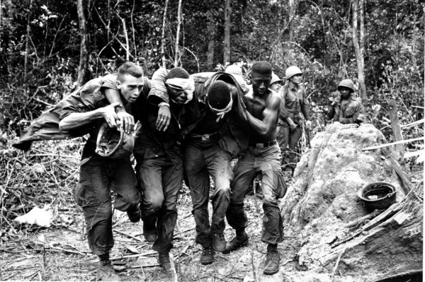 Wounded U.S. paratroopers are helped by fellow soldiers to a medical evacuation helicopter on Oct. 5, 1965 during the Vietnam War. Paratroopers of the 173rd Airborne Brigade's First Battalion suffered many casualties in the clash with Viet Cong guerrillas in the jungle of South Vietnam's "D" Zone, 25 miles Northeast of Saigon. (AP Photo)